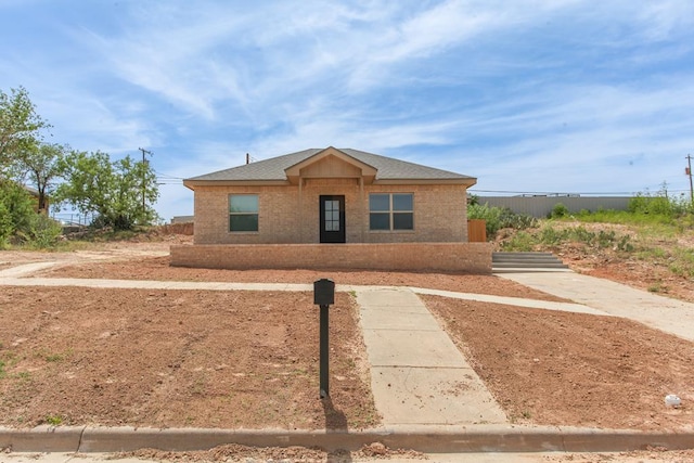 1202 Main St, Big Spring, TX 79720 - view of front facade with brick siding and roof with shingles