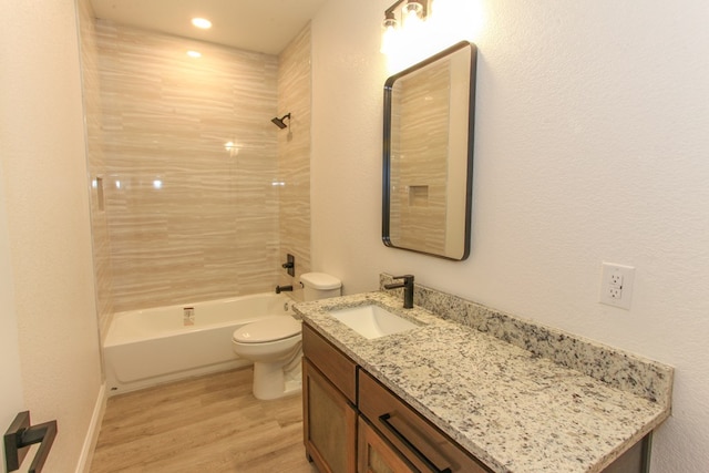 1202 Main St, Big Spring, TX 79720 - bathroom featuring toilet, wood finished floors, vanity, and shower / tub combination