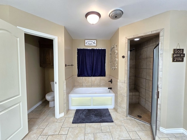 full bath with tile patterned flooring, toilet, baseboards, a bath, and a stall shower