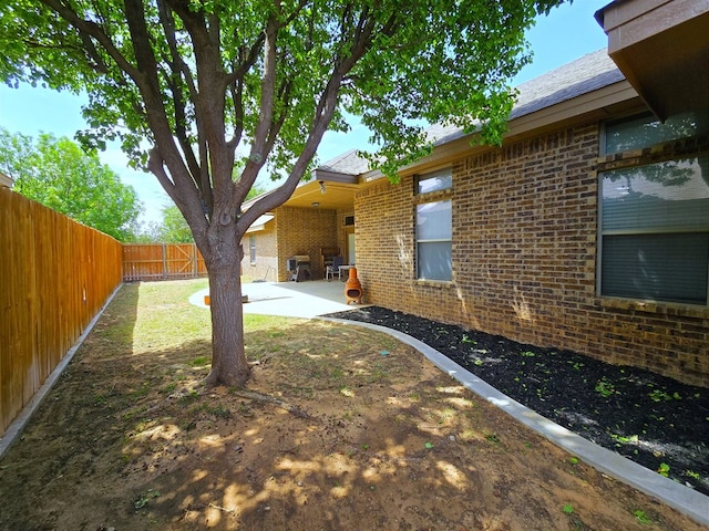 view of yard with a fenced backyard and a patio area
