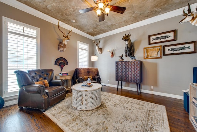 sitting room with ornamental molding, baseboards, ceiling fan, and dark wood-style floors