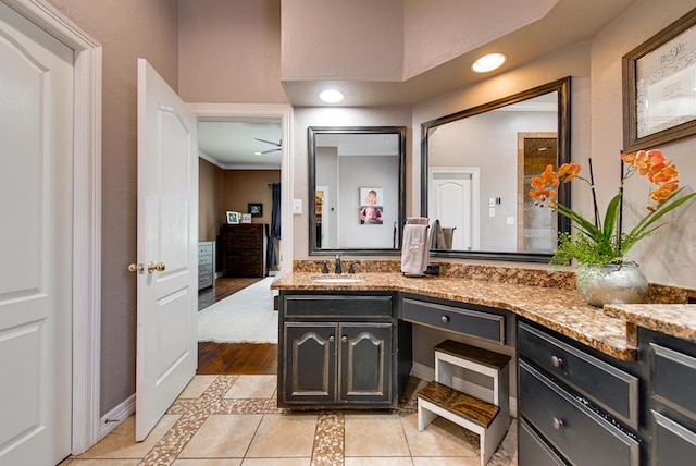 bathroom featuring tile patterned flooring, recessed lighting, and vanity