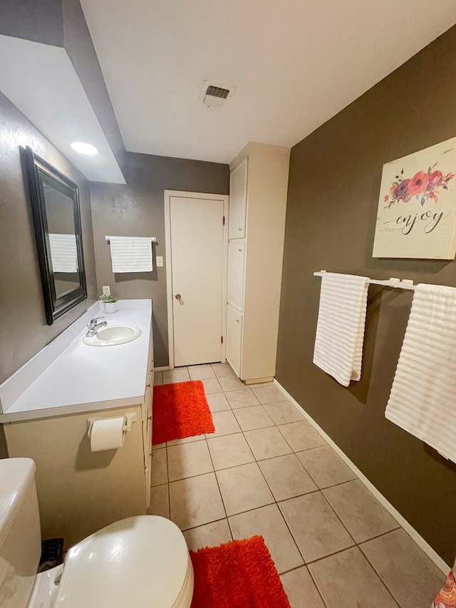 bathroom with vanity, tile patterned floors, and toilet