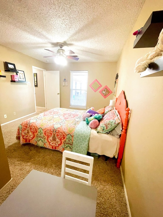 carpeted bedroom with a textured ceiling and ceiling fan