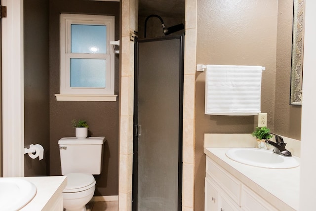 bathroom featuring vanity, toilet, and a shower with door