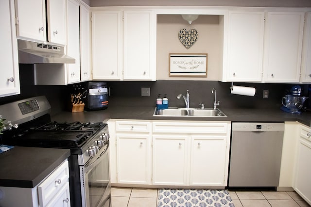 kitchen with white cabinetry, stainless steel appliances, light tile patterned flooring, and sink