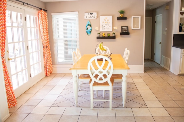 unfurnished dining area featuring light tile patterned floors