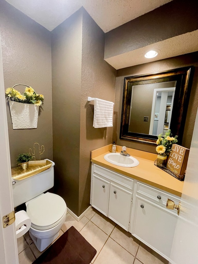 bathroom featuring tile patterned flooring, vanity, and toilet