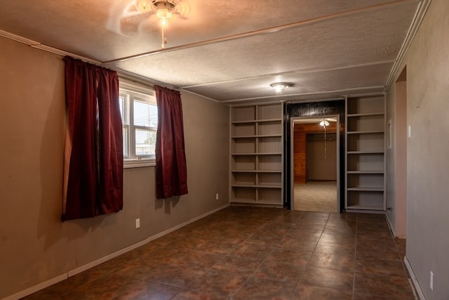 spare room with crown molding and a textured ceiling