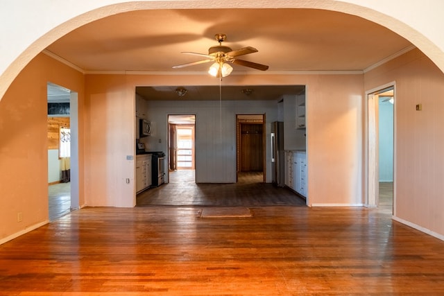 unfurnished room with wood-type flooring, ceiling fan, and ornamental molding