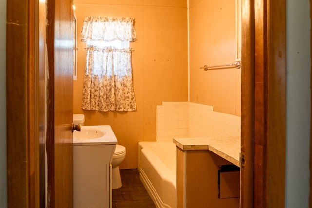 bathroom with vanity, toilet, and a bathtub