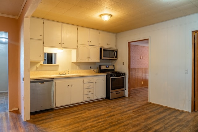 kitchen featuring appliances with stainless steel finishes, dark hardwood / wood-style floors, white cabinetry, and sink