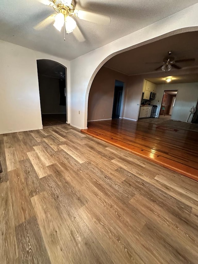 spare room with a textured ceiling, hardwood / wood-style flooring, and ceiling fan