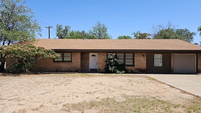 801 W Golf Course Rd, Midland, TX 79701 - ranch-style home featuring an attached garage, concrete driveway, and brick siding