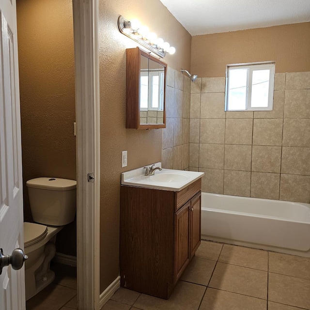 801 W Golf Course Rd, Midland, TX 79701 - bathroom featuring toilet, vanity, tile patterned floors, washtub / shower combination, and a textured wall