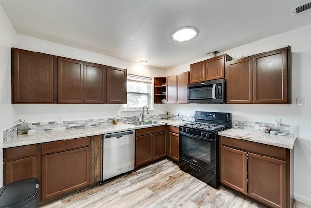 3004 W 4th, Odessa, TX 79763 - kitchen with stainless steel appliances, open shelves, and light wood-type flooring