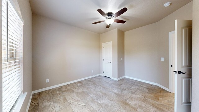 2894 SE 5001, Andrews, TX 79714 - empty room with ceiling fan, baseboards, and a smoke detector