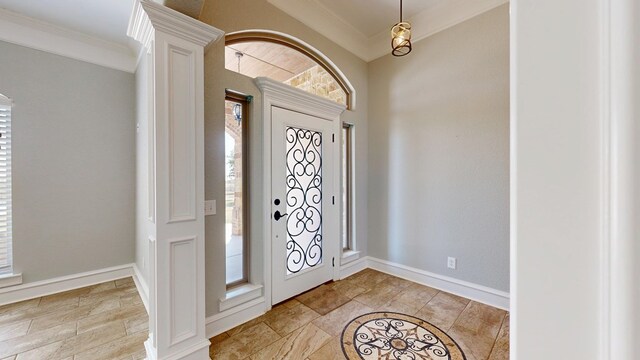 2894 SE 5001, Andrews, TX 79714 - foyer entrance featuring ornamental molding, ornate columns, and baseboards