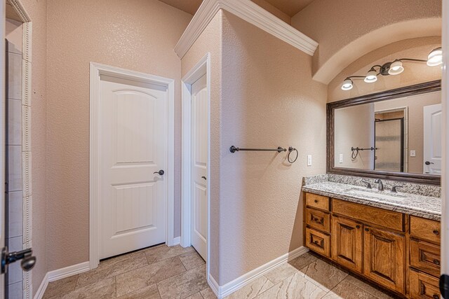 2894 SE 5001, Andrews, TX 79714 - bathroom with vanity, a textured wall, and baseboards