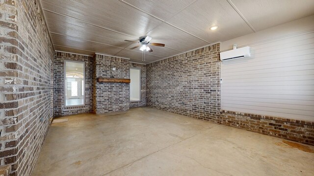 2894 SE 5001, Andrews, TX 79714 - unfurnished living room with an AC wall unit, unfinished concrete floors, ceiling fan, and brick wall