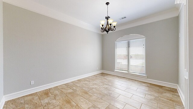 2894 SE 5001, Andrews, TX 79714 - unfurnished room featuring a chandelier, crown molding, baseboards, and arched walkways