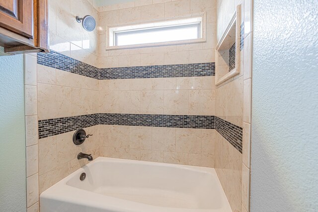 2894 SE 5001, Andrews, TX 79714 - bathroom featuring a textured wall and bathtub / shower combination