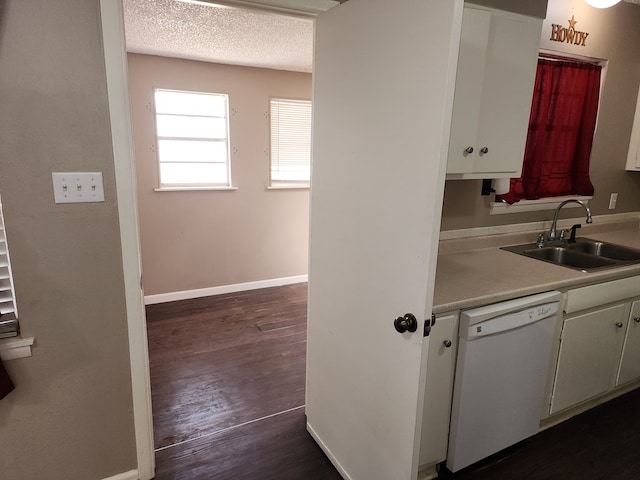 kitchen with white cabinetry, dishwasher, sink, dark hardwood / wood-style floors, and a textured ceiling