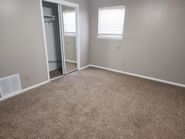 unfurnished bedroom with carpet and a closet