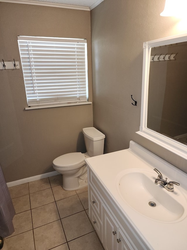 bathroom featuring toilet, vanity, and tile patterned floors