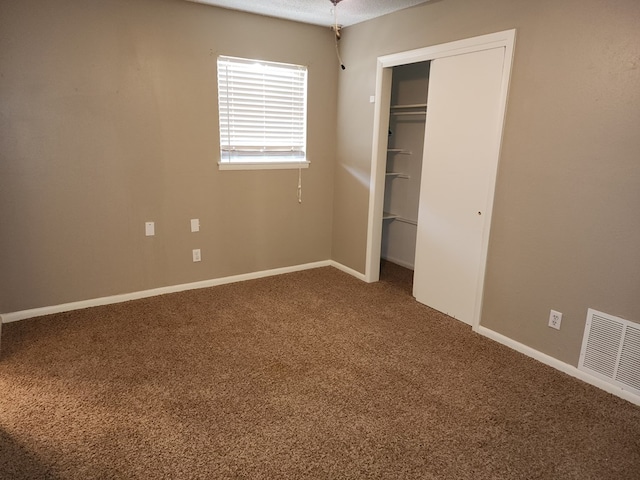 unfurnished bedroom with a closet and carpet