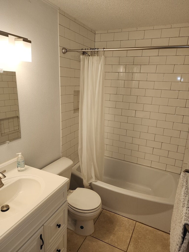 full bathroom featuring vanity, a textured ceiling, shower / tub combo with curtain, tile patterned flooring, and toilet