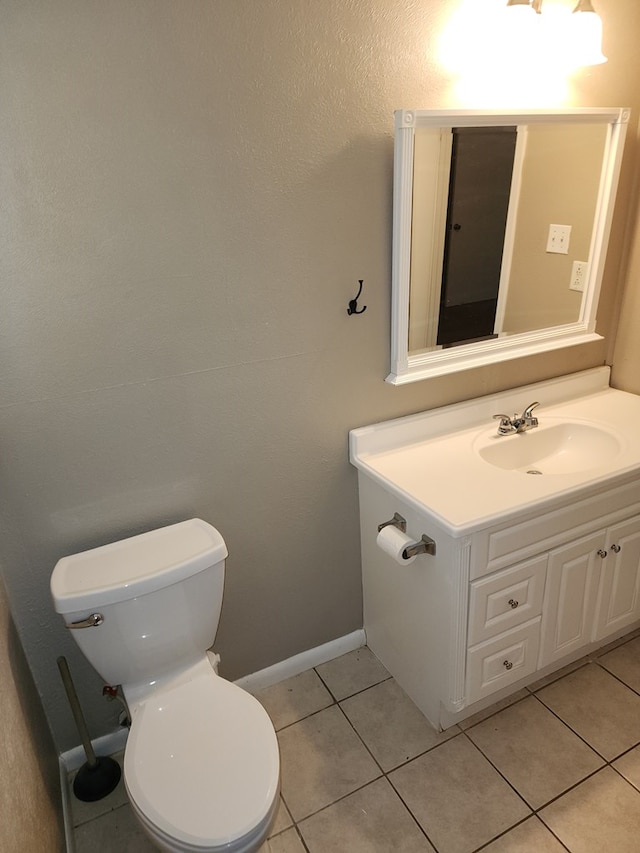 bathroom featuring tile patterned floors, vanity, and toilet