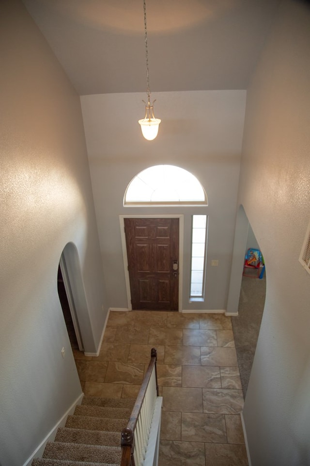 entrance foyer featuring high vaulted ceiling