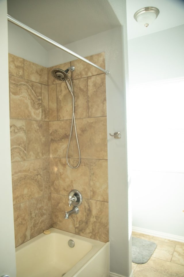 bathroom with tile patterned flooring and tiled shower / bath combo