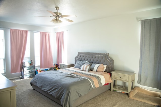 bedroom featuring ceiling fan, carpet floors, and a textured ceiling