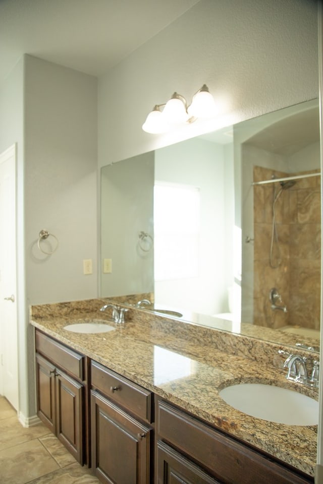 bathroom featuring vanity and tiled shower / bath