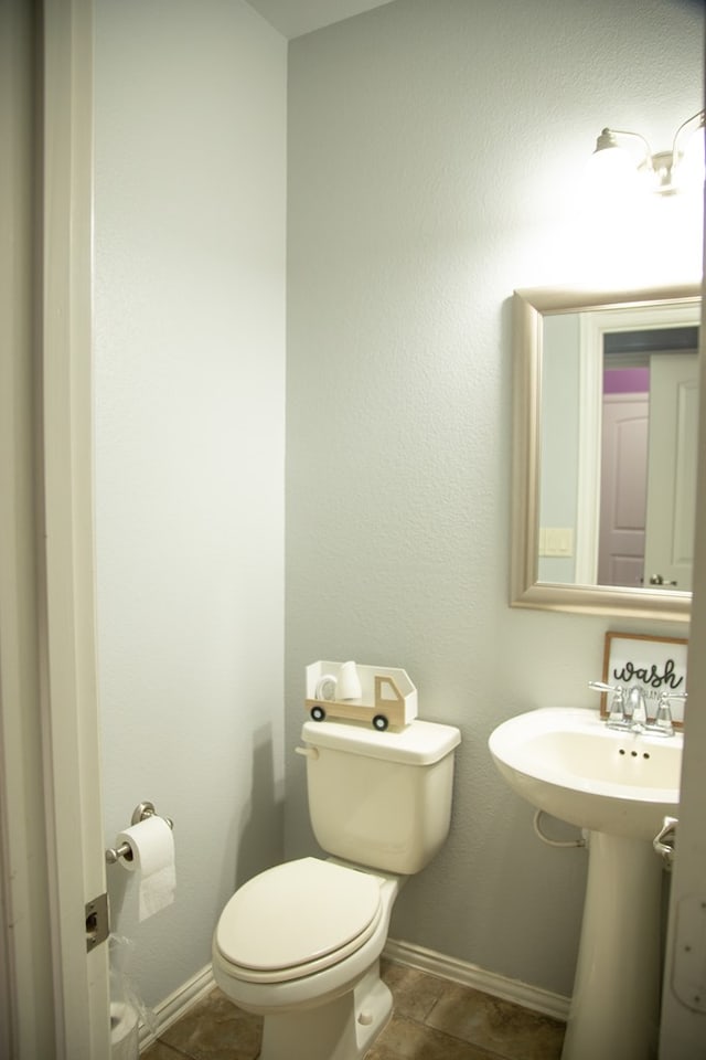 bathroom with tile patterned floors and toilet