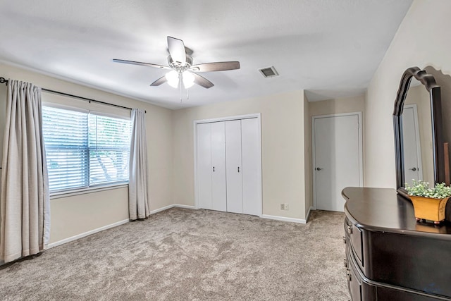 2512 Sinclair Ave, Midland, TX 79705 - bedroom featuring light colored carpet, baseboards, a closet, and ceiling fan