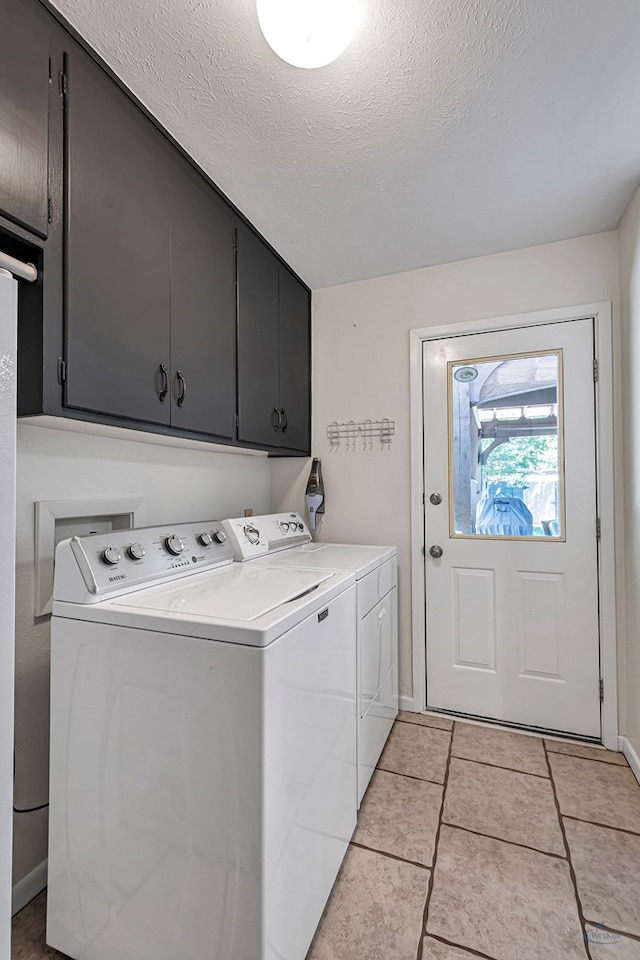 2512 Sinclair Ave, Midland, TX 79705 - washroom with separate washer and dryer, cabinet space, baseboards, a textured ceiling, and light tile patterned flooring