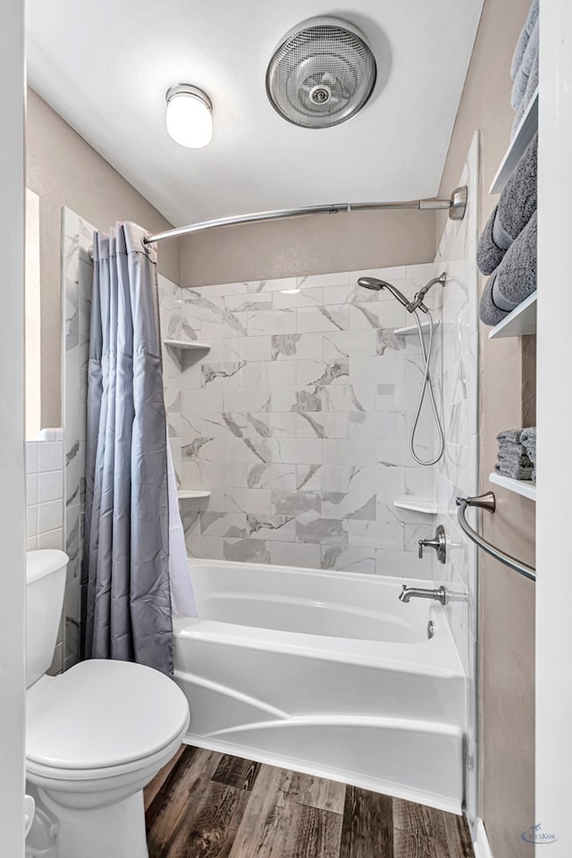 2512 Sinclair Ave, Midland, TX 79705 - bathroom featuring shower / bath combo with shower curtain, toilet, wood finished floors, and tile walls