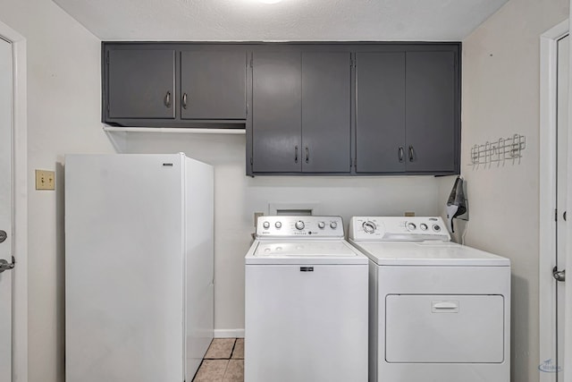 2512 Sinclair Ave, Midland, TX 79705 - washroom with cabinet space, separate washer and dryer, light tile patterned floors, and baseboards