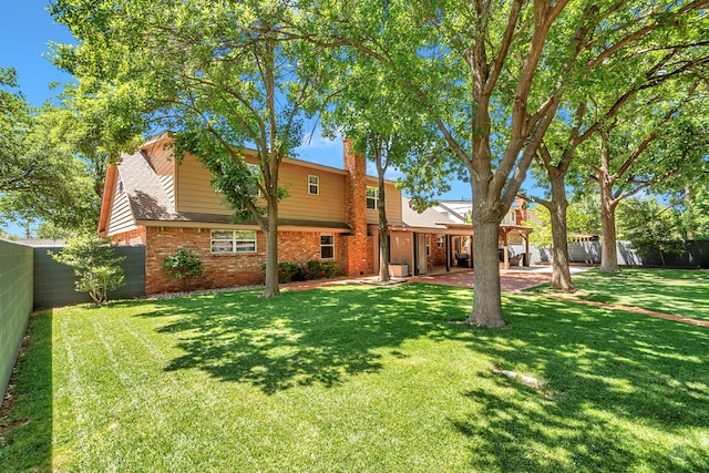 2512 Sinclair Ave, Midland, TX 79705 - rear view of property with brick siding, a patio area, a chimney, and a shingled roof