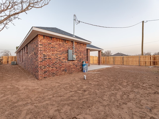 property exterior at dusk with a patio