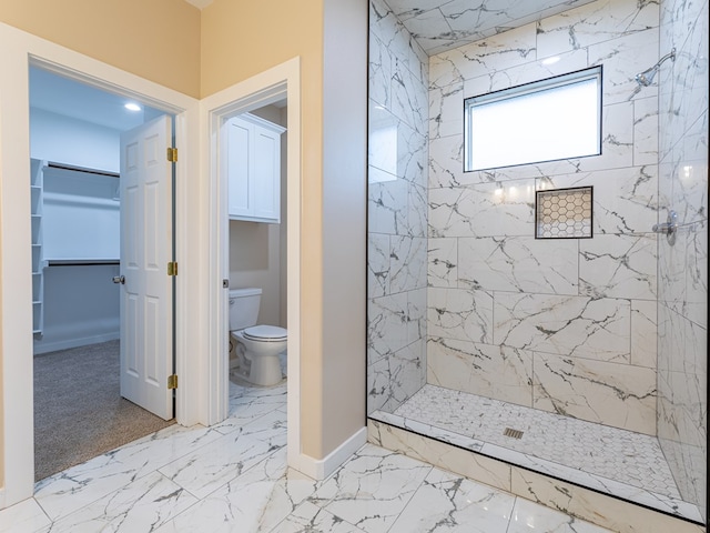 bathroom featuring toilet and tiled shower