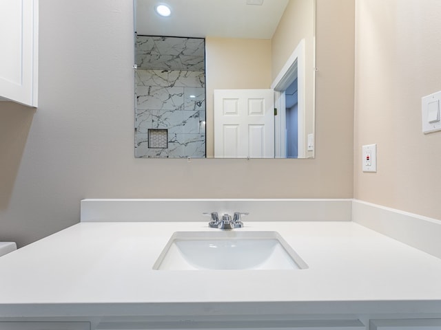 bathroom with walk in shower and vanity