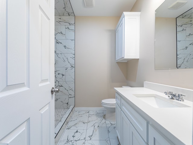 bathroom featuring toilet, a shower, and vanity