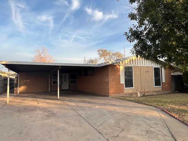 ranch-style home featuring a carport