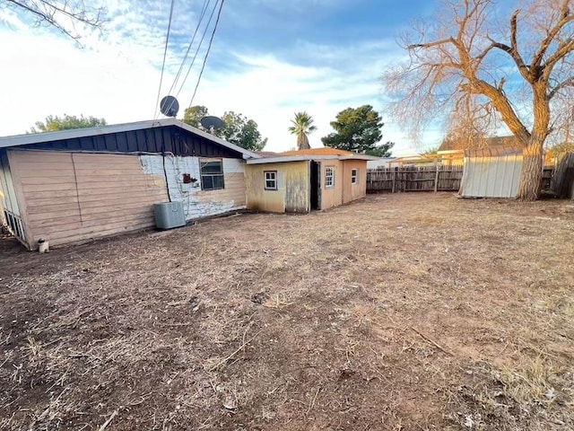 exterior space featuring central air condition unit and a shed