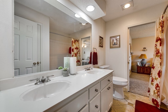 5500 Heartland Ct, Midland, TX 79707 - full bathroom featuring double vanity, tile patterned flooring, curtained shower, and a textured ceiling