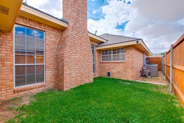 5500 Heartland Ct, Midland, TX 79707 - back of property featuring a chimney, brick siding, a fenced backyard, and roof with shingles